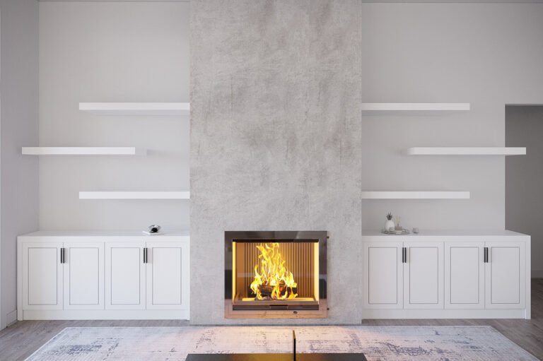 A modern, minimalist living room with a large, gray concrete fireplace as the focal point. The fireplace is surrounded by built-in white cabinets and shelves, providing ample storage and display space. The room features a clean, uncluttered design with a warm, cozy ambiance created by the flickering flames in the fireplace.