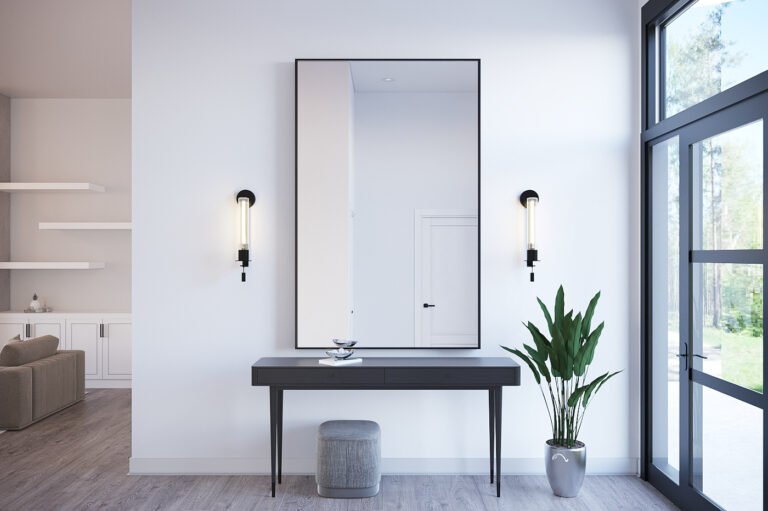 A modern and minimalist entryway featuring a large framed mirror, a sleek black console table, and a potted plant. The room is filled with natural light from the large windows, creating a bright and airy atmosphere. The clean lines and monochromatic color scheme give the space a sophisticated and elegant feel.