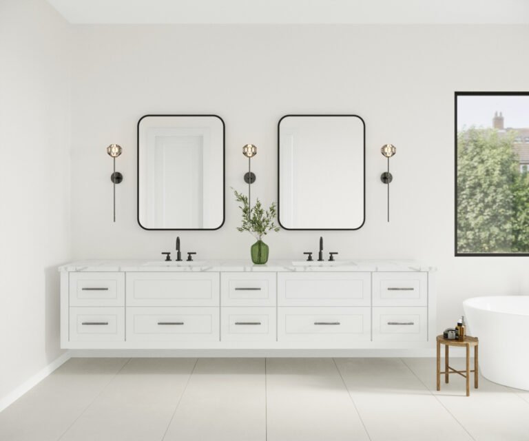 A modern and minimalist bathroom interior featuring a long white vanity with multiple drawers, two rectangular wall mirrors with black frames, and wall sconces with globe-shaped glass shades. A small green vase with greenery sits on the vanity, and a window in the background provides natural light and a view of the outdoors.