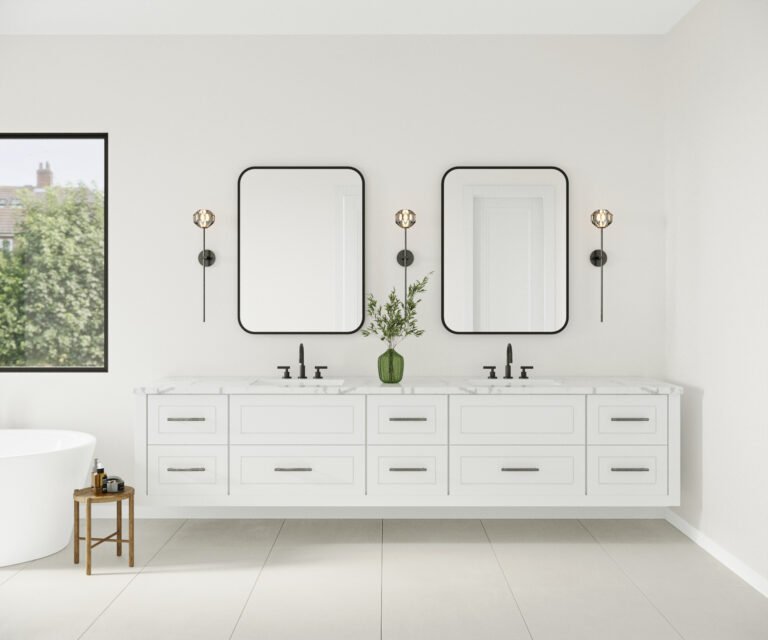 A modern and minimalist bathroom vanity with a white cabinet, marble countertop, and two black-framed mirrors. The vanity features multiple drawers for storage, and the room is accented with a potted plant and wall sconces. The large window in the background provides natural lighting and a view of the outdoors.